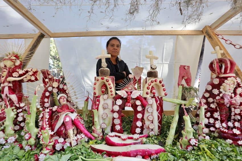 Participants have carved a wide array of figures in the past, from mariachis to Mexican luchadores. Here, a 2023 participant shows off religious figures made out of radishes.